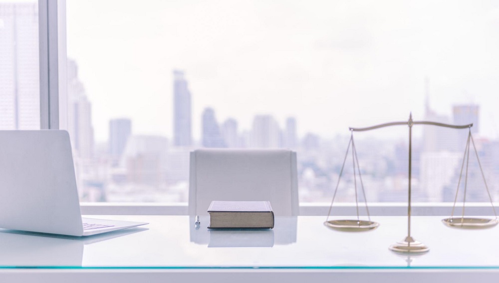 Law office with the scales of justice featured on the desk